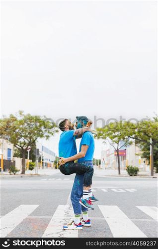 homosexual couple hugging holi festival