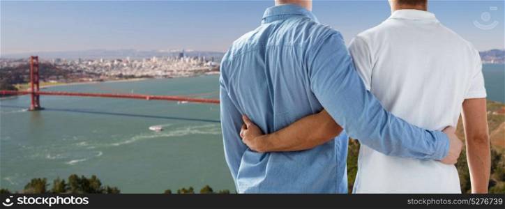 homosexual relationships, same-sex marriage and lgbt concept - close up of happy male gay couple hugging over golden gate bridge in san francisco bay background. close up of gay couple over golden gate bridge