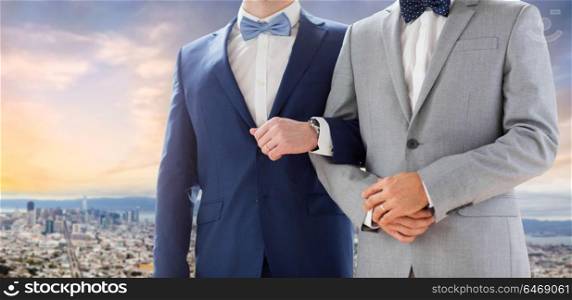 homosexual, same-sex marriage and tolerance concept - close up of happy male gay couple holding hands on wedding over san francisco city view background. close up of male gay couple over san francisco