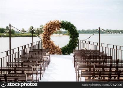 Hona wedding ceremony on the pier near the water