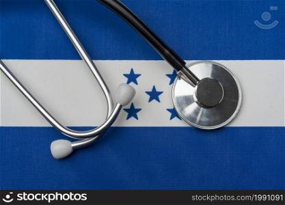 Honduras flag and stethoscope. The concept of medicine. Stethoscope on the flag as a background.. Honduras flag and stethoscope. The concept of medicine.