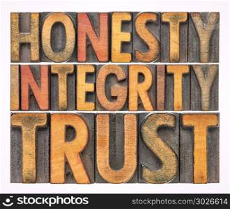 honesty, integrity, trust word abstract in wood type. honesty, integrity, trust - isolated word abstract in vintage letterpress wood type blocks stained by color inks