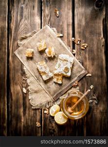Honey background. Natural honey lemon slices and walnuts. On wooden background.. Honey background. Natural honey lemon slices and walnuts.