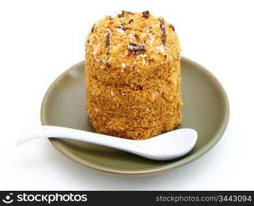 Honey cake with chocolate on a white background