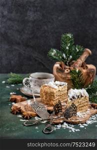 Honey cake with spices and Christmas decoration on dark background. Festive sweet food