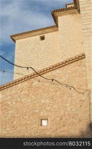 Honey-colored stone masonry on large buildings in the center of Binissalem, Majorca, Spain.