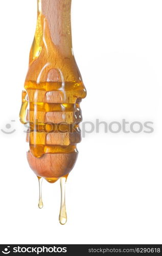 Honey dripping from a wooden honey dipper