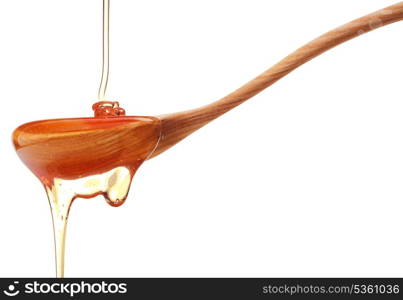 Honey dripping from a wooden honey dipper isolated on white background cutout