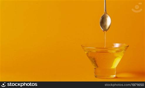 honey dripping off spoon bowl. High resolution photo. honey dripping off spoon bowl. High quality photo