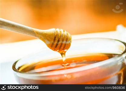 honey dripping on honey jar - selective focus