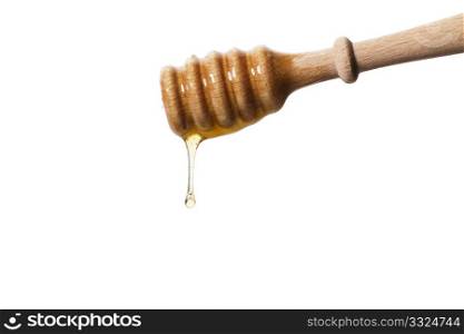 honey drops from a honey dipper. honey drops from a honey dipper on white background
