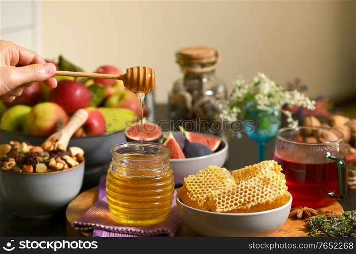 Honey, Honeycomb, Tea, Dried Fruits and Figs on Autumn Table