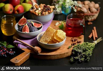 Honey, Honeycomb, Tea, Dried Fruits and Figs on Autumn Table