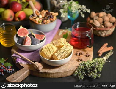 Honey, Honeycomb, Tea, Dried Fruits and Figs on Autumn Table