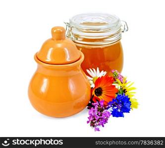 Honey in a clay jug and a glass jar with flowers isolated on white background
