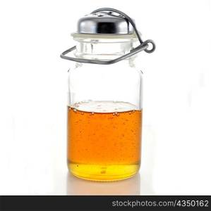 honey in a glass jar on white background