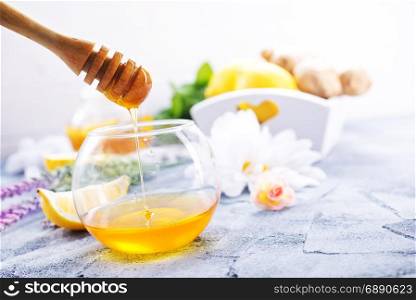 honey in glass and on a table