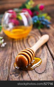 honey in glass bowl and on a table