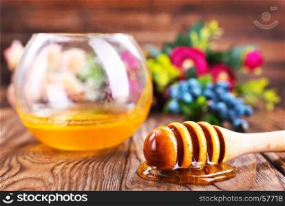 honey in glass bowl and on a table