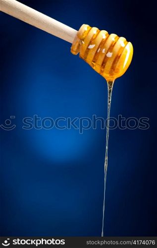 honey is dripping from the spoon, cut out from white