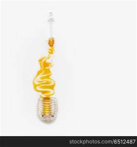 Honey poured from glass jar with dipper on white background, top view. Healthy food