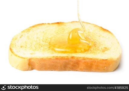 honey pouring down to white bread. isolated on white