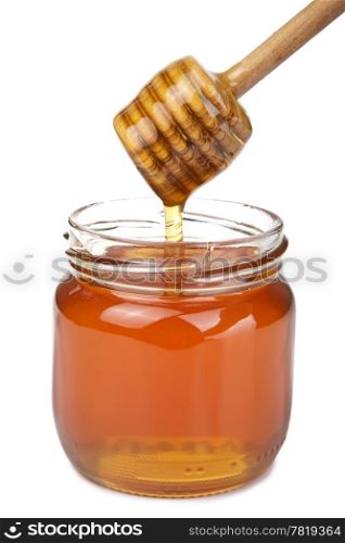 honey pouring in jar isolated