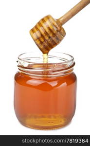 honey pouring in jar isolated