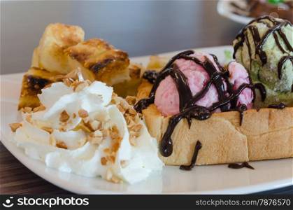 honey toast and ice cream. Honey toast and whipping cream with chocolate sauce and ice cream