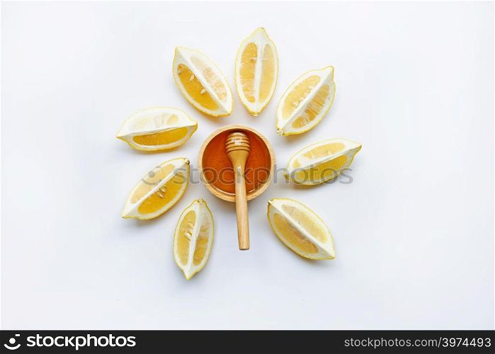 Honey with lemon on white background.