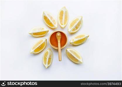 Honey with lemon on white background.