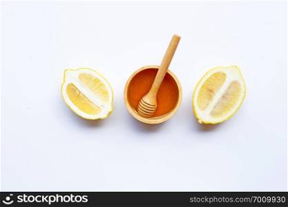 Honey with lemon on white background. Copy space