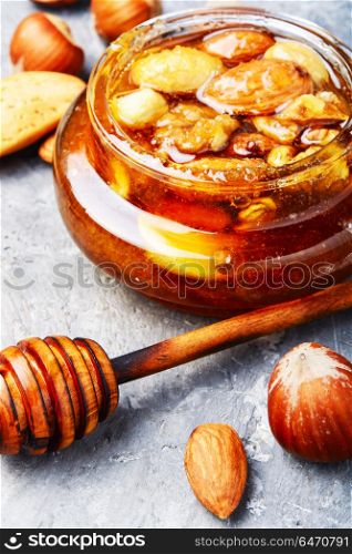 Honey with nuts. Honey with walnuts, almonds and hazelnuts. Natural food
