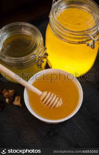 Honey with walnut. Honey with walnut on wooden background