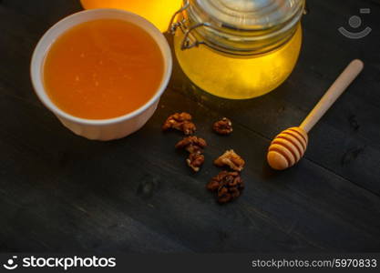 Honey with walnut. Honey with walnut on wooden background