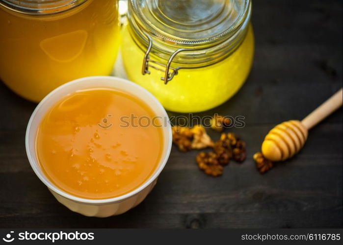 Honey with walnut. Honey with walnut on wooden background