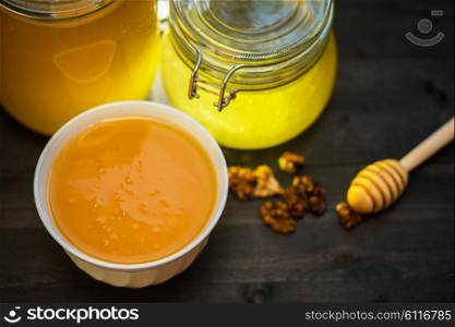 Honey with walnut. Honey with walnut on wooden background