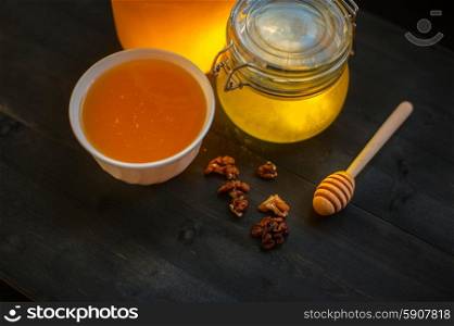 Honey with walnut on wooden background. Honey with walnut