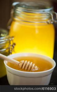 Honey with wooden spoon. Honey with wooden spoon closeup photo
