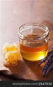 honeycomb and honey in jar on wooden background
