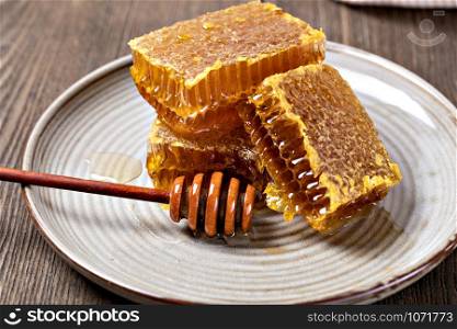 Honeycomb slice on a wooden table. Honeycomb slice