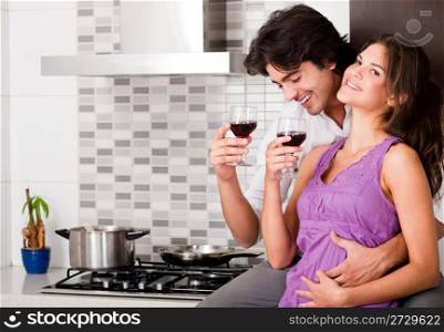 honeymoon couple drinking wine in kitchen