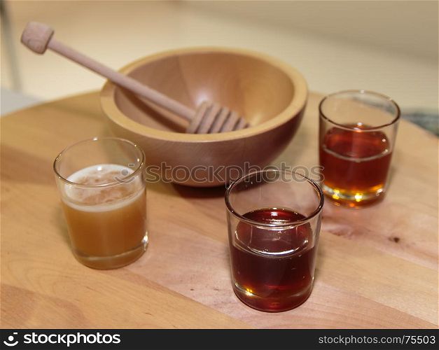 Honeys Assortment Type inside Glass and Wooden Honey Dipper and Bowl