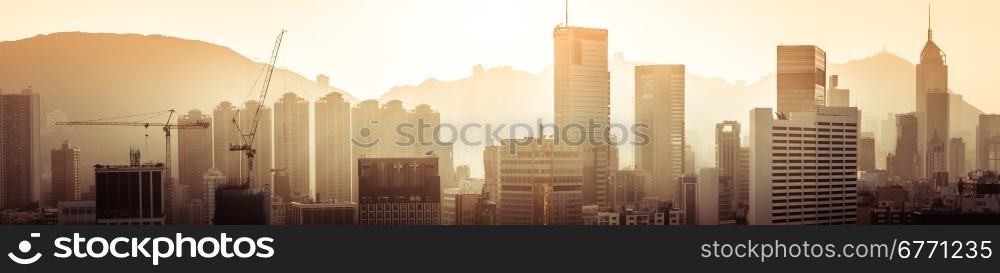 Hong Kong aerial cityscape panorama view with building construction near Victoria Harbor at sunset. Asia travel destinations