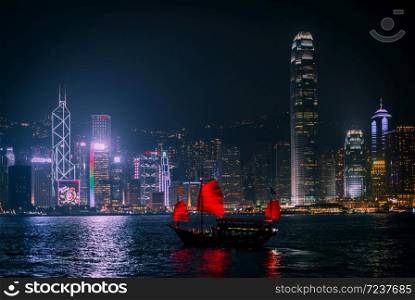 HONG KONG - DECEMBER 8, 2013: Illuminated Chinese red junk (Aqualuna) on Victoria Harbour, Hong Kong, on a foggy Winter night.
