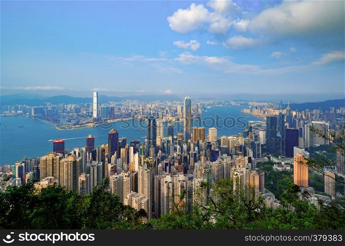 Hong Kong Downtown from Victoria Peak. Financial district and business centers in smart city and technology concept. skyscraper and high-rise office buildings with blue sky.