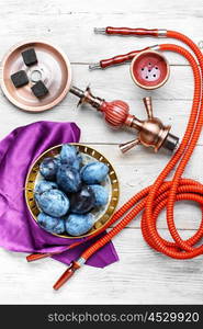 Hookah and autumn plum. Still life with smoking hookah and the harvest of autumn plums