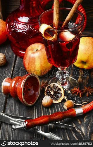 Hookah and mulled wine. Smoking hookah tobacco with apple aroma and stylish Arabic lantern