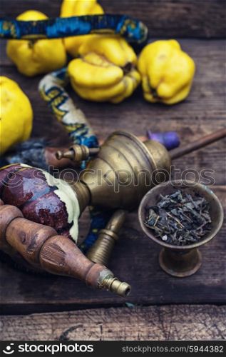 Hookah and quince.. Disassembled the hookah in wooden box with fresh fruit quince in a vintage style