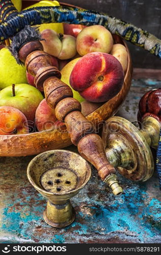 hookah. Details were worked hookah on the table amid fresh peaches.Photo tinted.